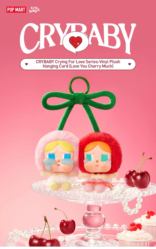 Pop Mart Cry baby, love you cherry much. Two vinyl plush dolls on a stand with cherry decorations against a pink background, featuring the brand 'Pop Mart'.