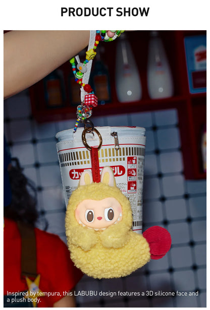 Popmart the Monsters wacky mart series. Yellow plush keychain with a 3D silicone face attached to a cylindrical product.