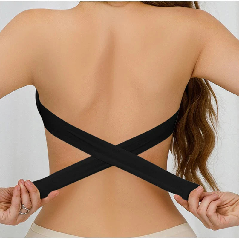 Person wearing a black criss-cross back strap on a plain background