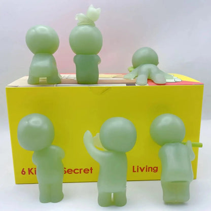 Smiski, living room series. Set of green figurines in front of a yellow box with 'Secret Living' branding.