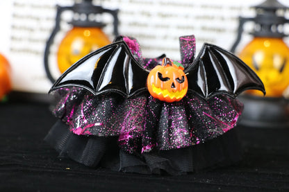 Labubu Halloween dress. Halloween-themed decorative item with bat wings and pumpkin on a black background