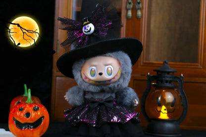 Labubu Halloween dress. Halloween-themed plush toy with a witch hat and pumpkin lanterns in the background.