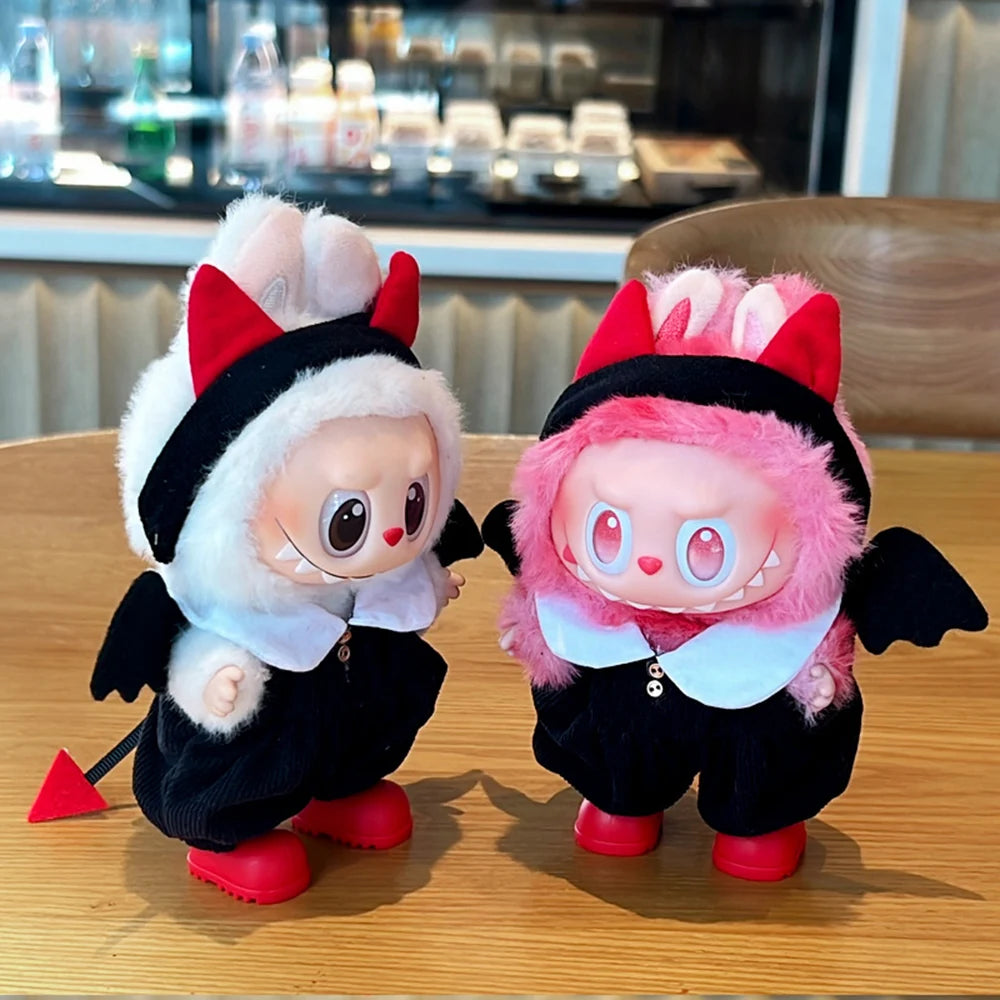Two Labubu toys resembling  devil costumes on a wooden table.