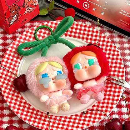 Pop Mart Cry baby, love you cherry much. Two cartoon-style figurines on a plate with cherries and a checkered tablecloth.
