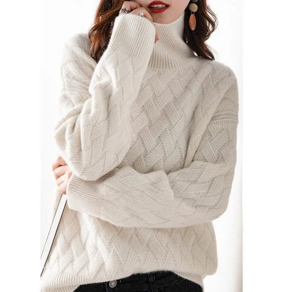 White cable knit sweater worn by a person on a white background