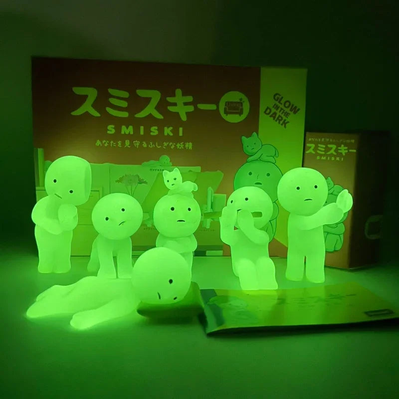 Smiski, living room series. Glowing green toy figures with packaging in the background