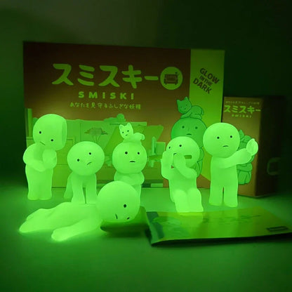 Smiski, living room series. Glowing green toy figures with packaging in the background