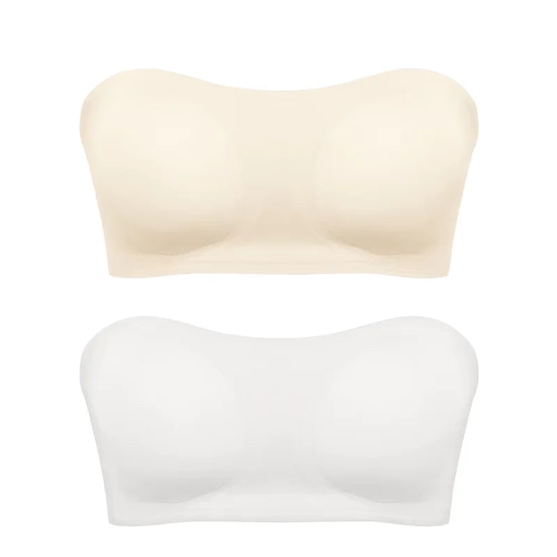Two strapless bras, one beige and one white, on a white background