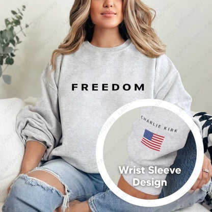 Person wearing a gray sweatshirt with 'FREEDOM' text and a close-up of a wrist sleeve design.
