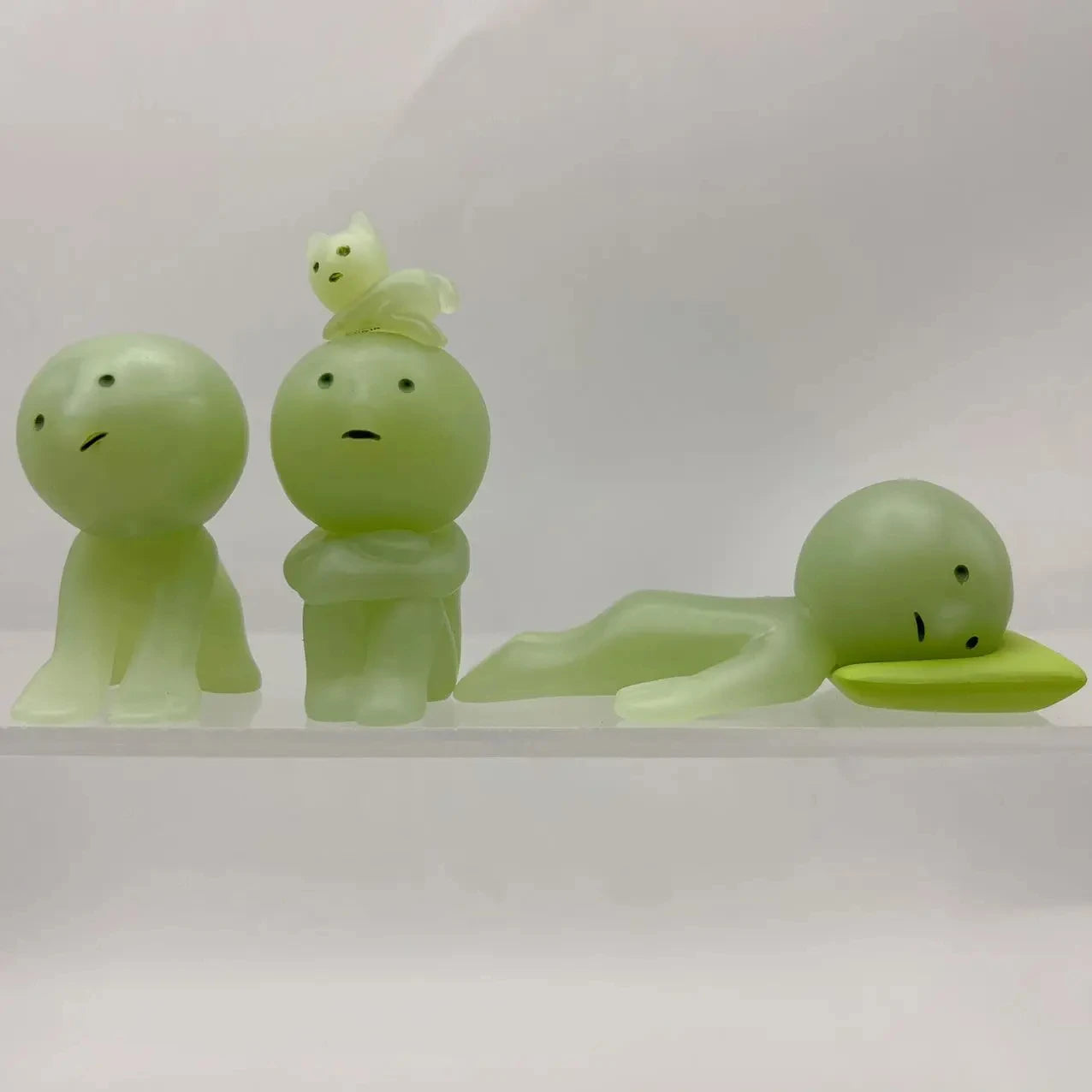 Smiski, living room series. Three green rubber duck toys on a white background