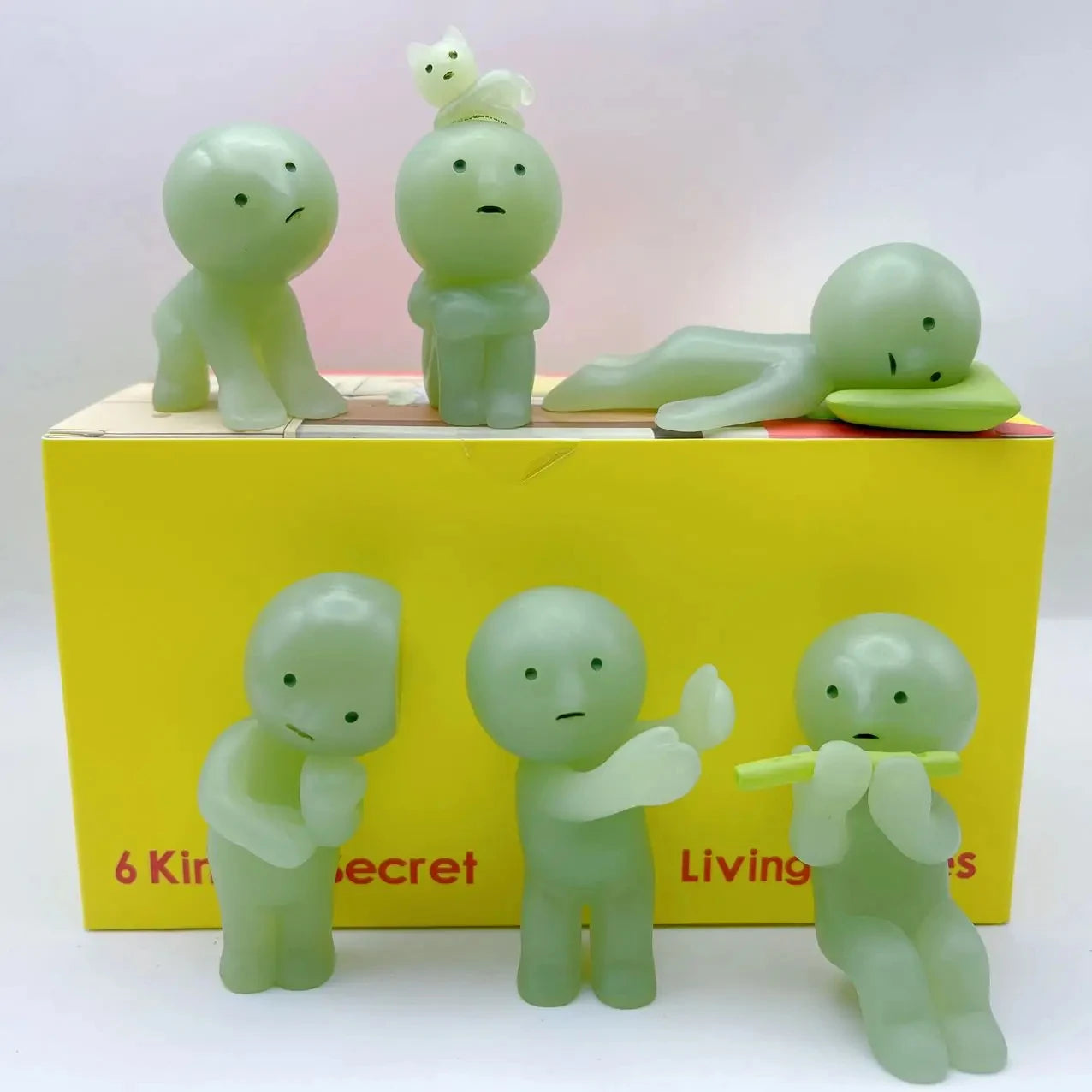 Smiski, living room series. Set of six green figurines on a yellow box with text