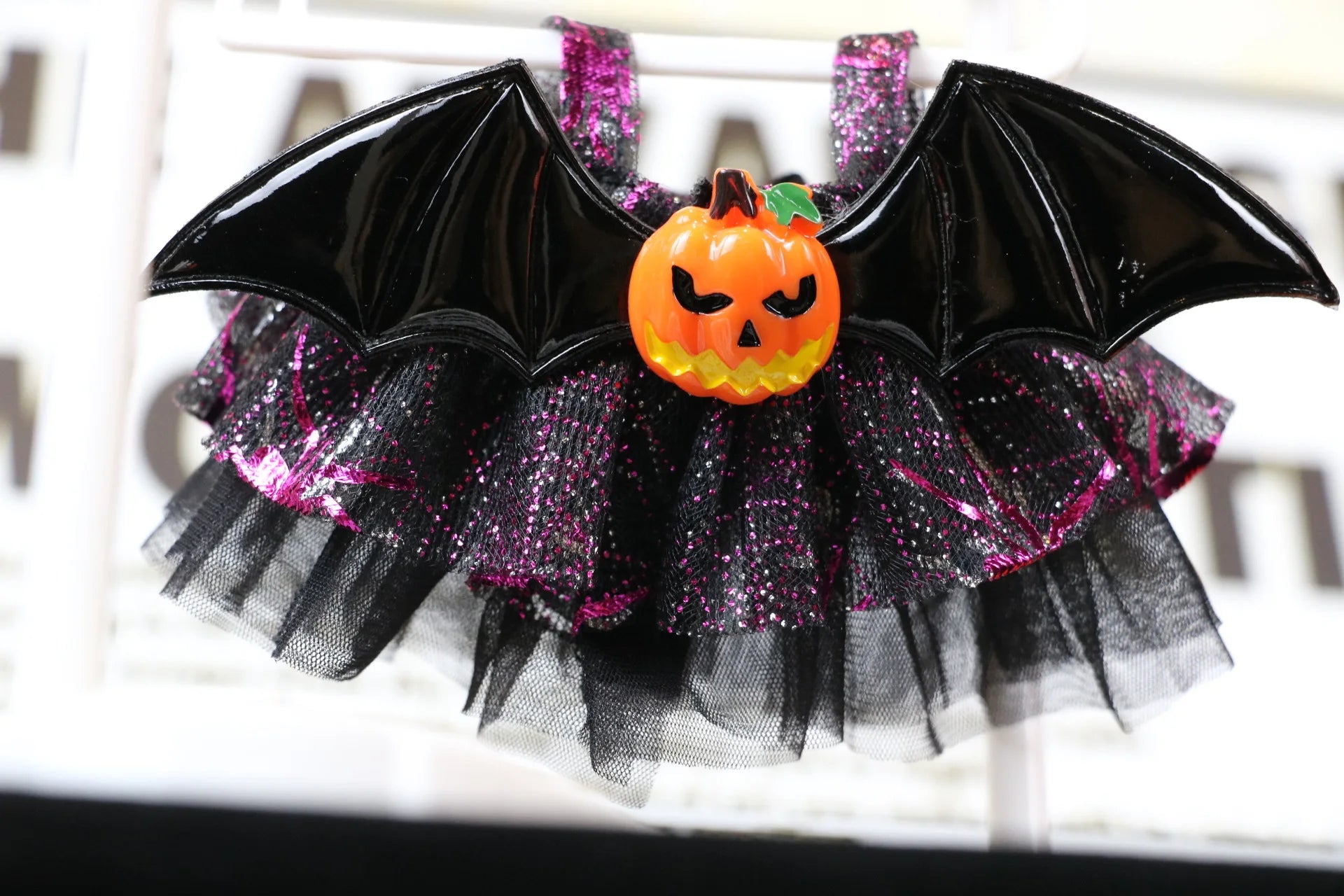 Labubu Halloween dress. Halloween-themed tutu with bat wings and pumpkin decoration on a white background