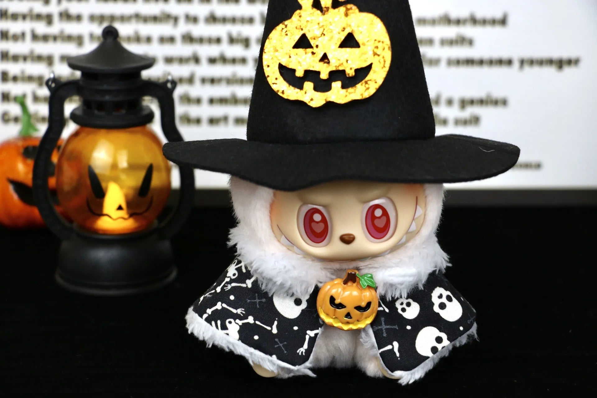Labubu Halloween dress. Halloween-themed plush toy with witch hat and pumpkin decorations on a dark background