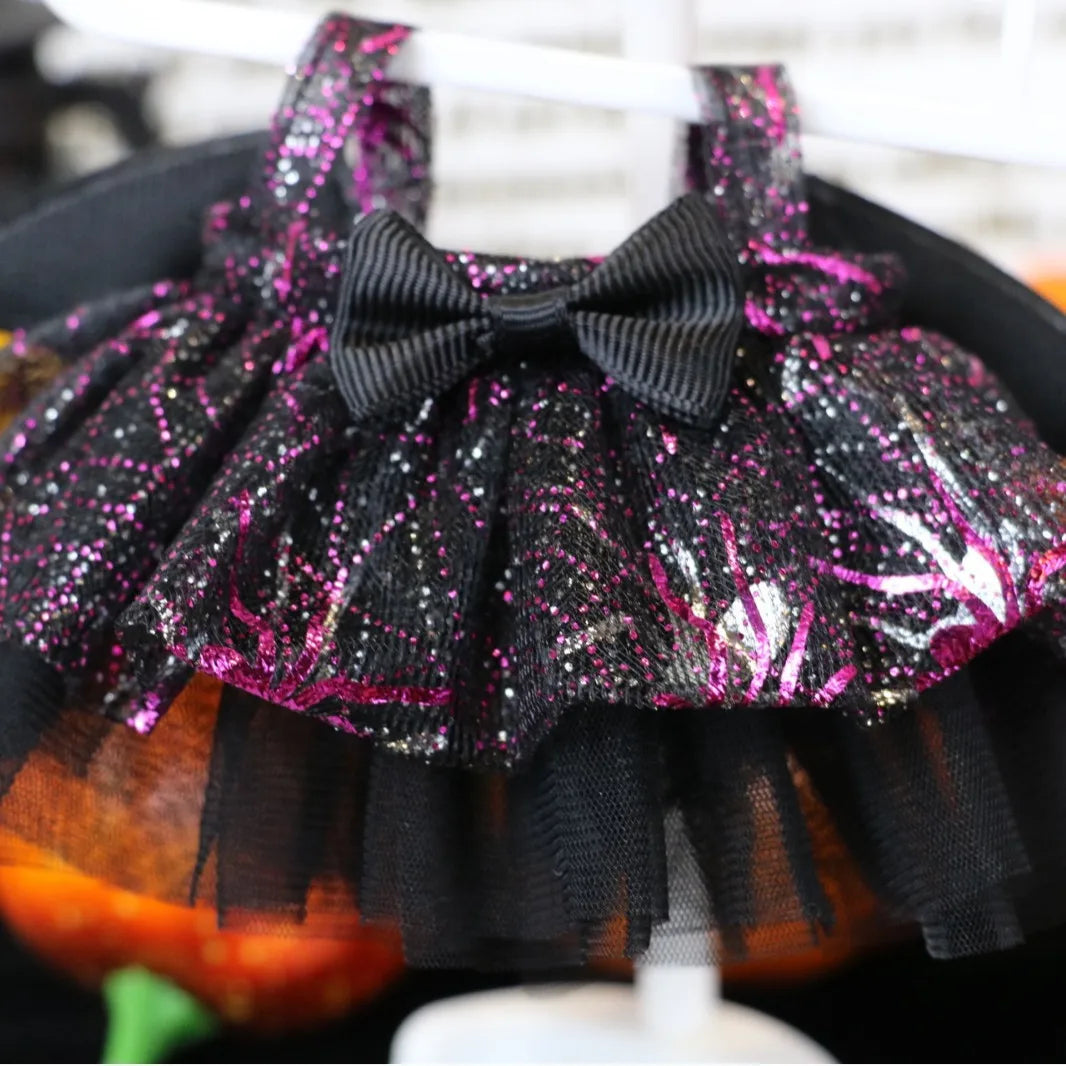 Labubu Halloween dress. Black and pink glittery Halloween-themed pet costume with a bow on a mannequin.