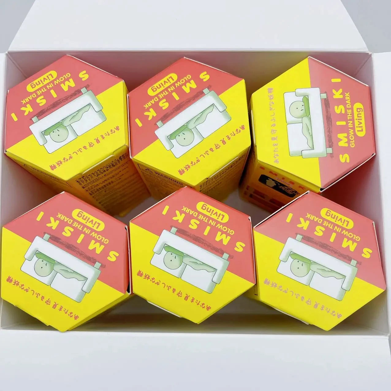Six hexagonal boxes of SMISKI products arranged in a box.