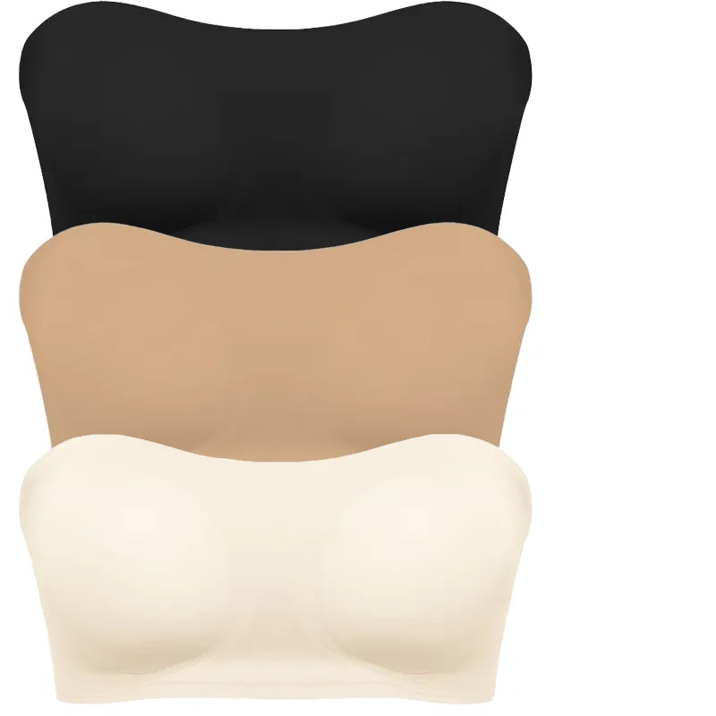 Black, beige, and white strapless tops on a white background