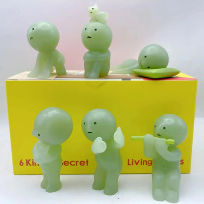 Smiski, living room series. Set of green character figurines on a yellow box with text