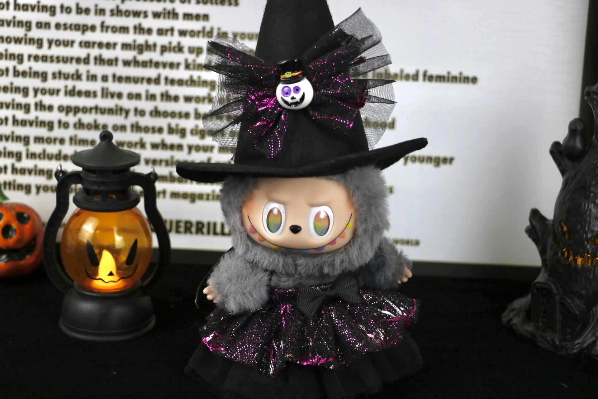 Labubu Halloween dress. Halloween-themed plush toy with witch costume and decorations on a festive background.