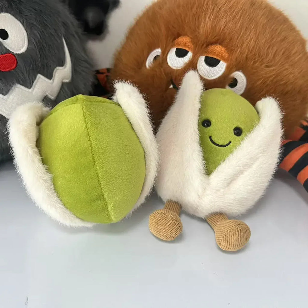  pistachio. Plush toy resembling a character with a green ball and brown body on a white background