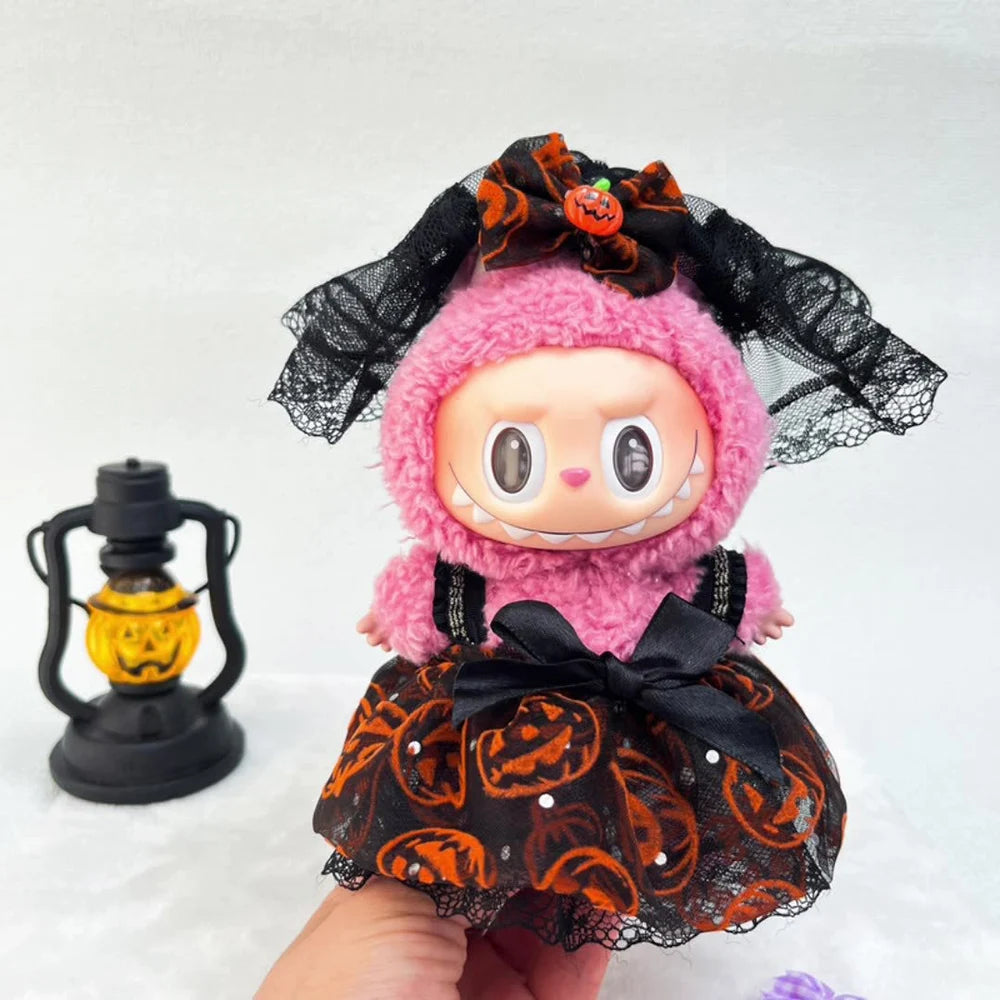 Halloween-themed Labubu with pink hair and black lace dress, held by a hand with a lantern in the background.