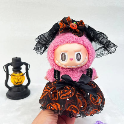 Halloween-themed Labubu with pink hair and black lace dress, held by a hand with a lantern in the background.