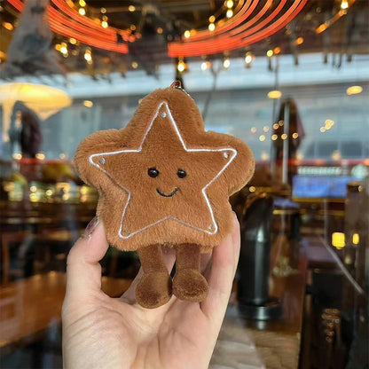 Jellycat. Star-shaped plush toy held in a hand with a blurred indoor background