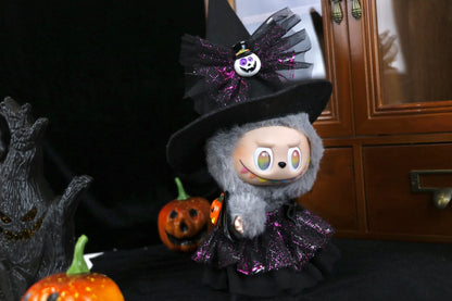 Labubu in a witch costume with Halloween decorations