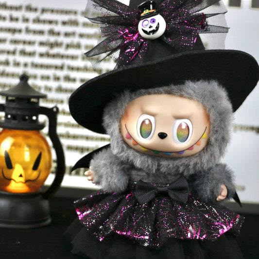 Labubu Halloween dress. Halloween-themed plush toy with a black hat and purple skirt, sitting next to a pumpkin lantern.
