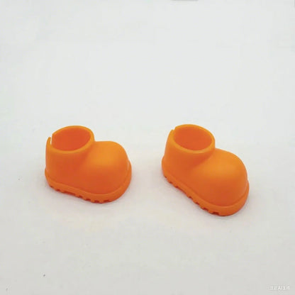 Labubu boots. Pair of orange rubber boots on a white background