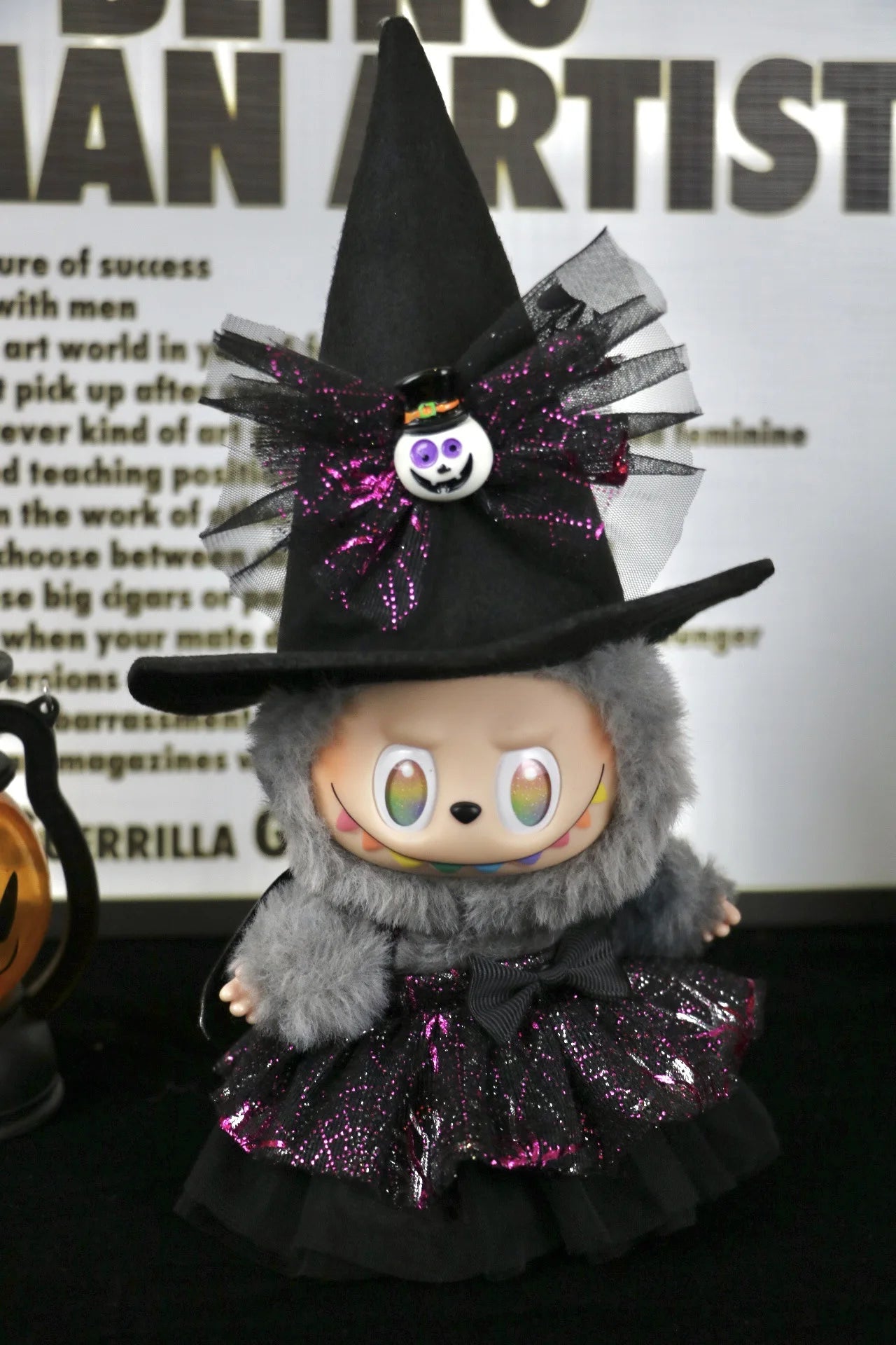 Labubu Halloween dress. Halloween-themed plush toy with witch costume and hat on a dark background