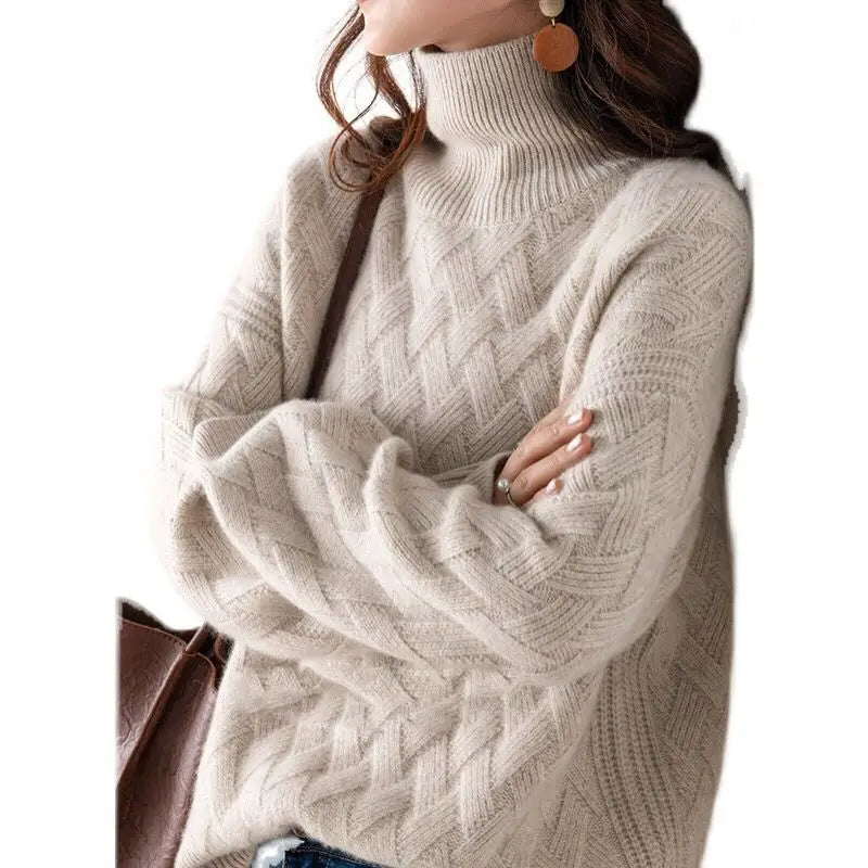Beige cable knit sweater worn by a person on a white background